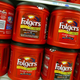 Rows of Folgers coffee canisters at grocery store